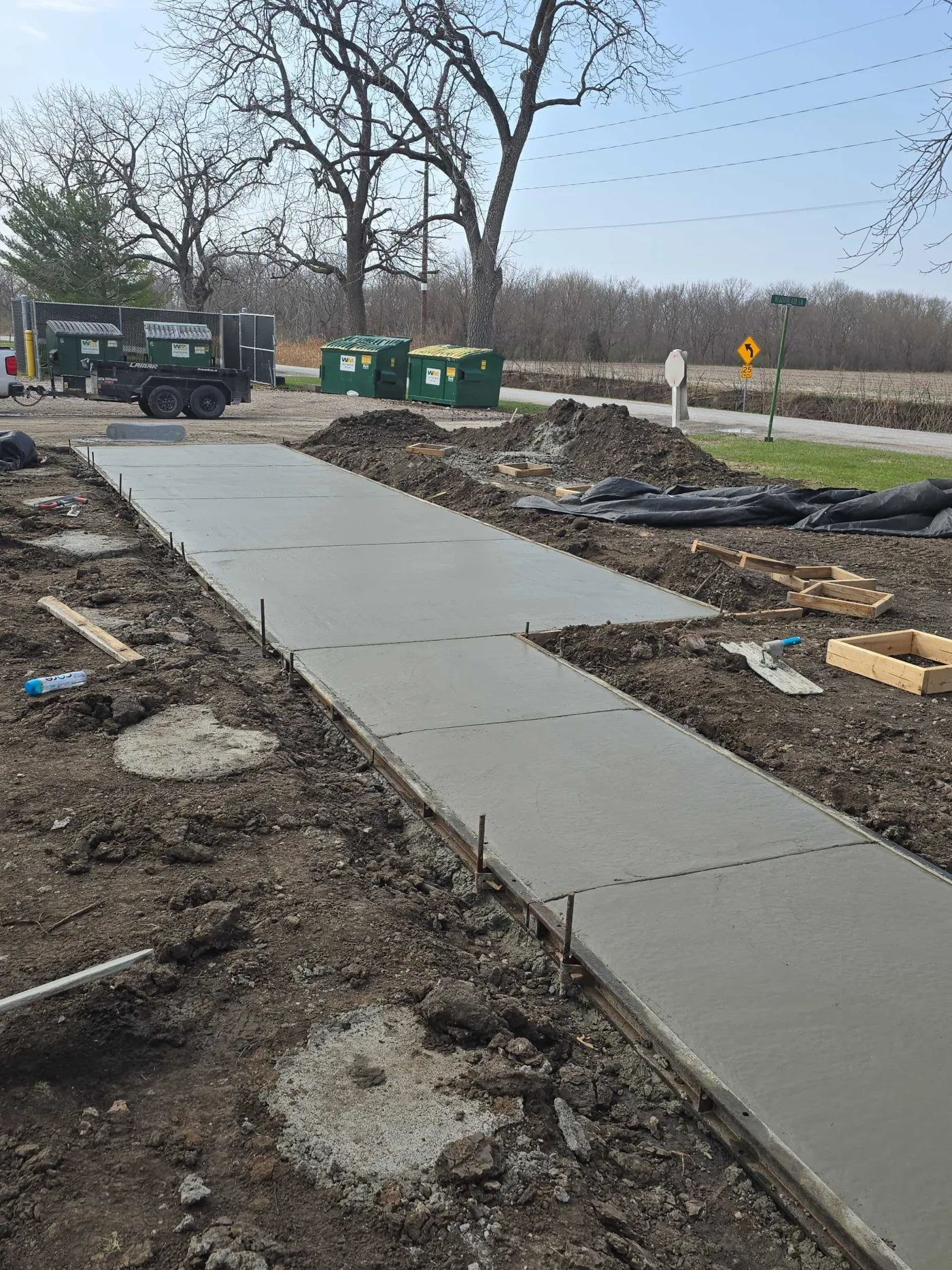 Fresh concrete walkway poured with forms still in place